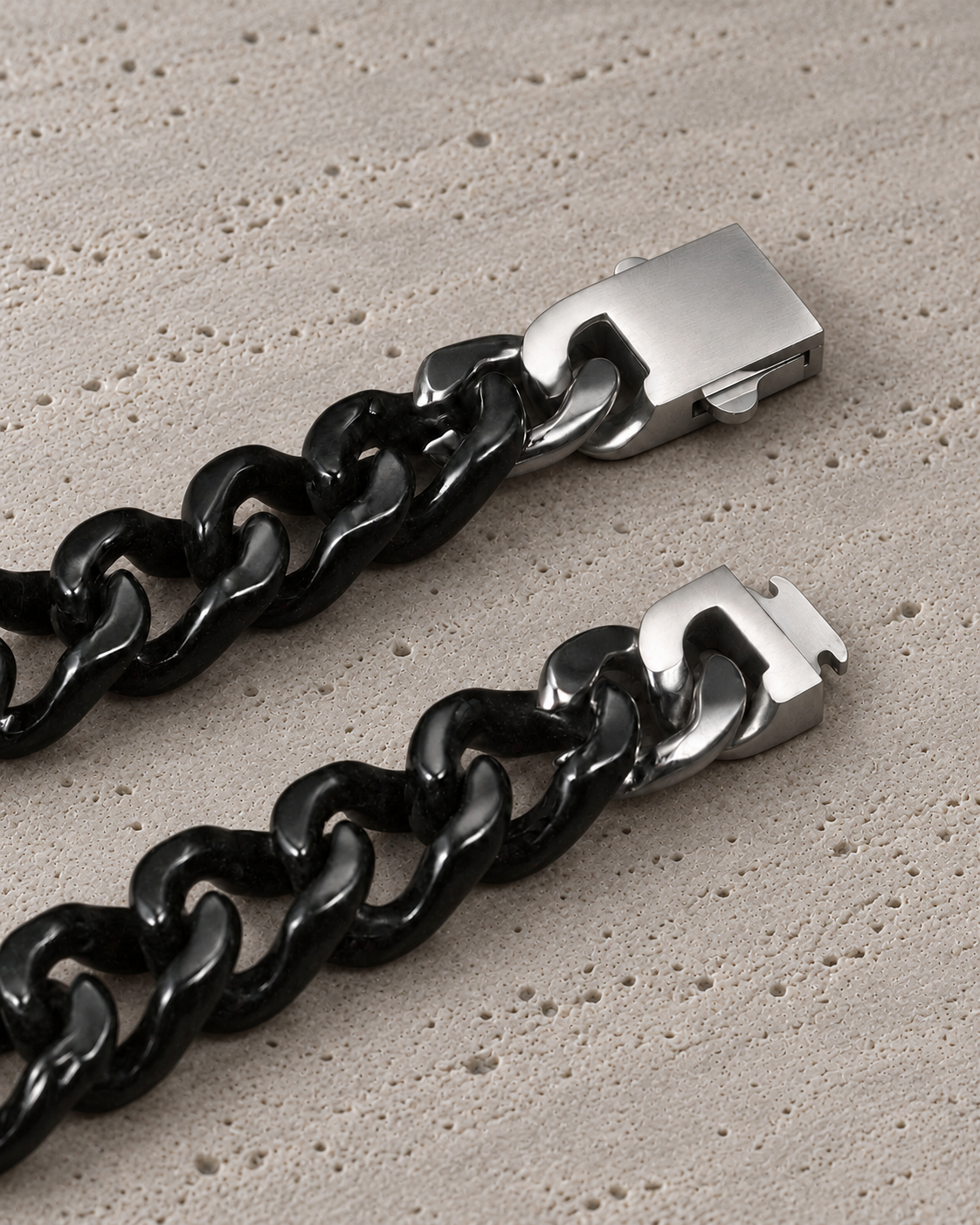 Single Piece Carved Cuban Chain Bracelet in Black Jade, clasp close-up on matte grey stone.