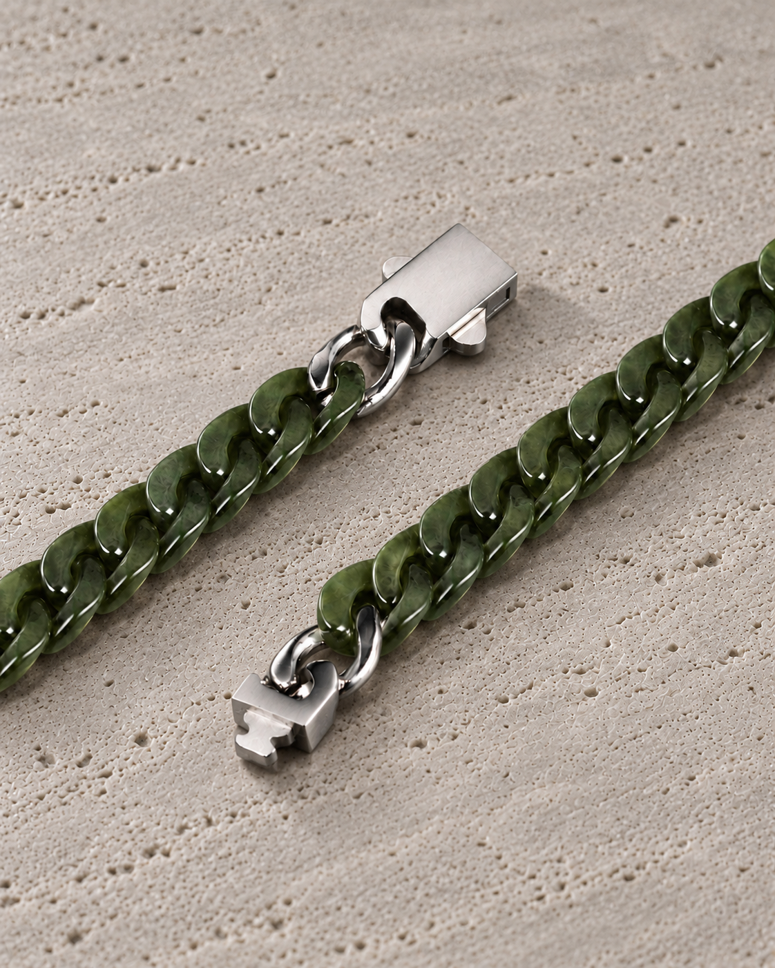 Classic Cuban Link Chain Bracelet in Light Green Nephrite, clasp close-up on matte grey stone.