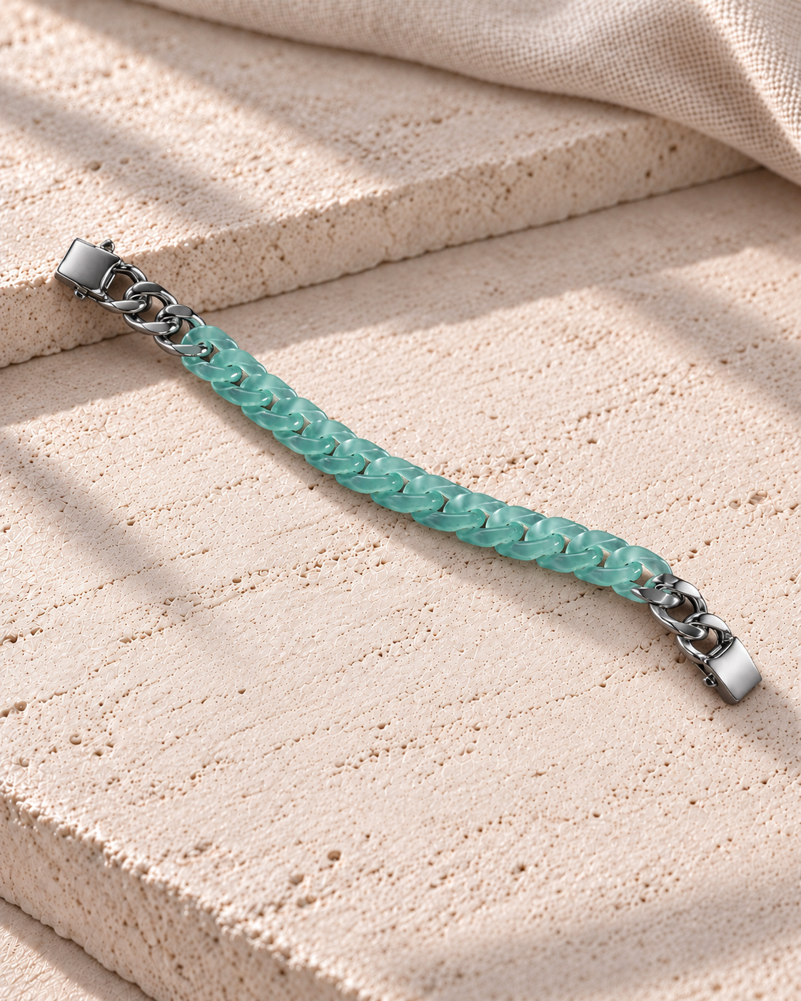 Classic Cuban Link Chain Bracelet in Blue-Green Jadeite, product view on pale limestone.