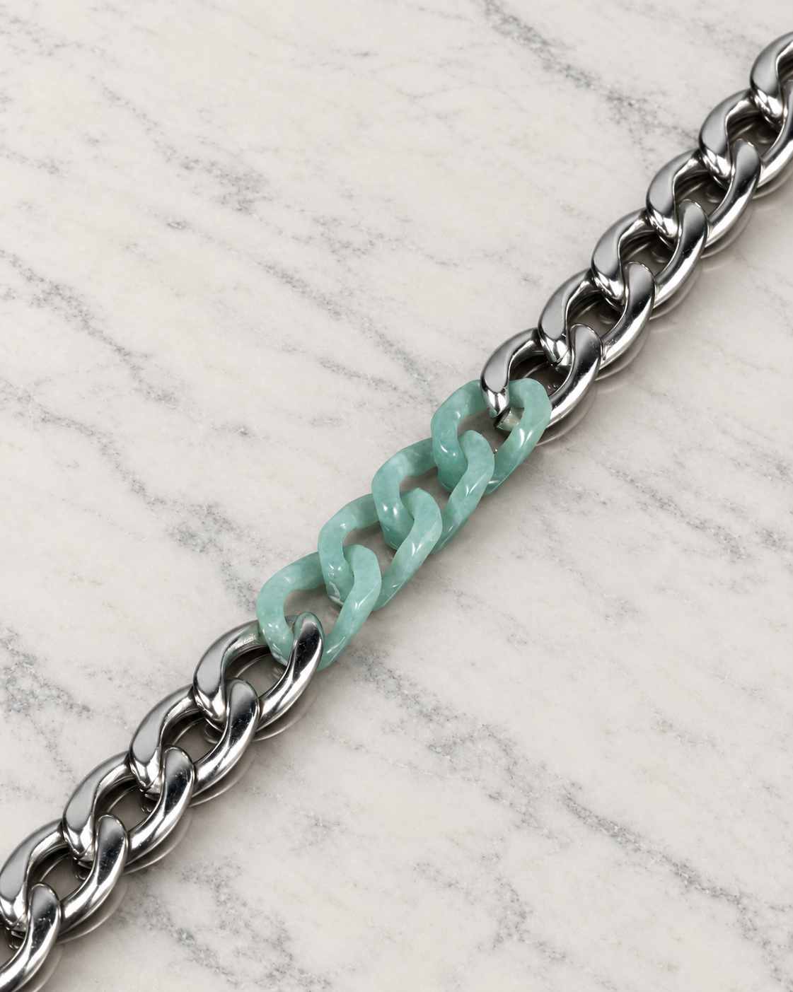 Classic Cuban Chain Bracelet in Green Jade with Stainless Steel, material and construction close-up on ivory marble.