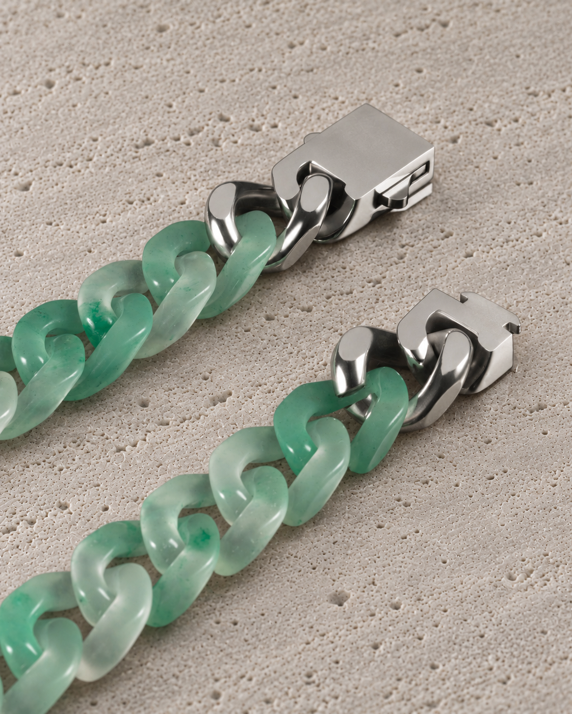 Classic Cuban Link Chain Bracelet in African Green Jade, clasp close-up on matte grey stone.