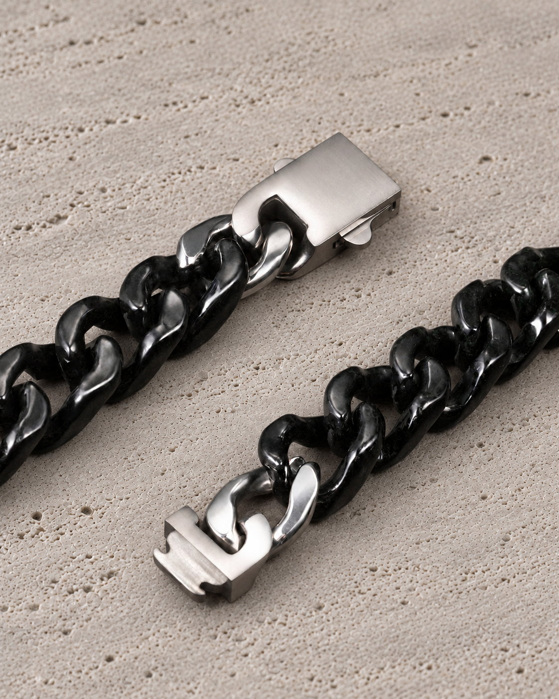 Single Piece Carved Cuban Chain Bracelet in Black Jade, clasp close-up on matte grey stone.