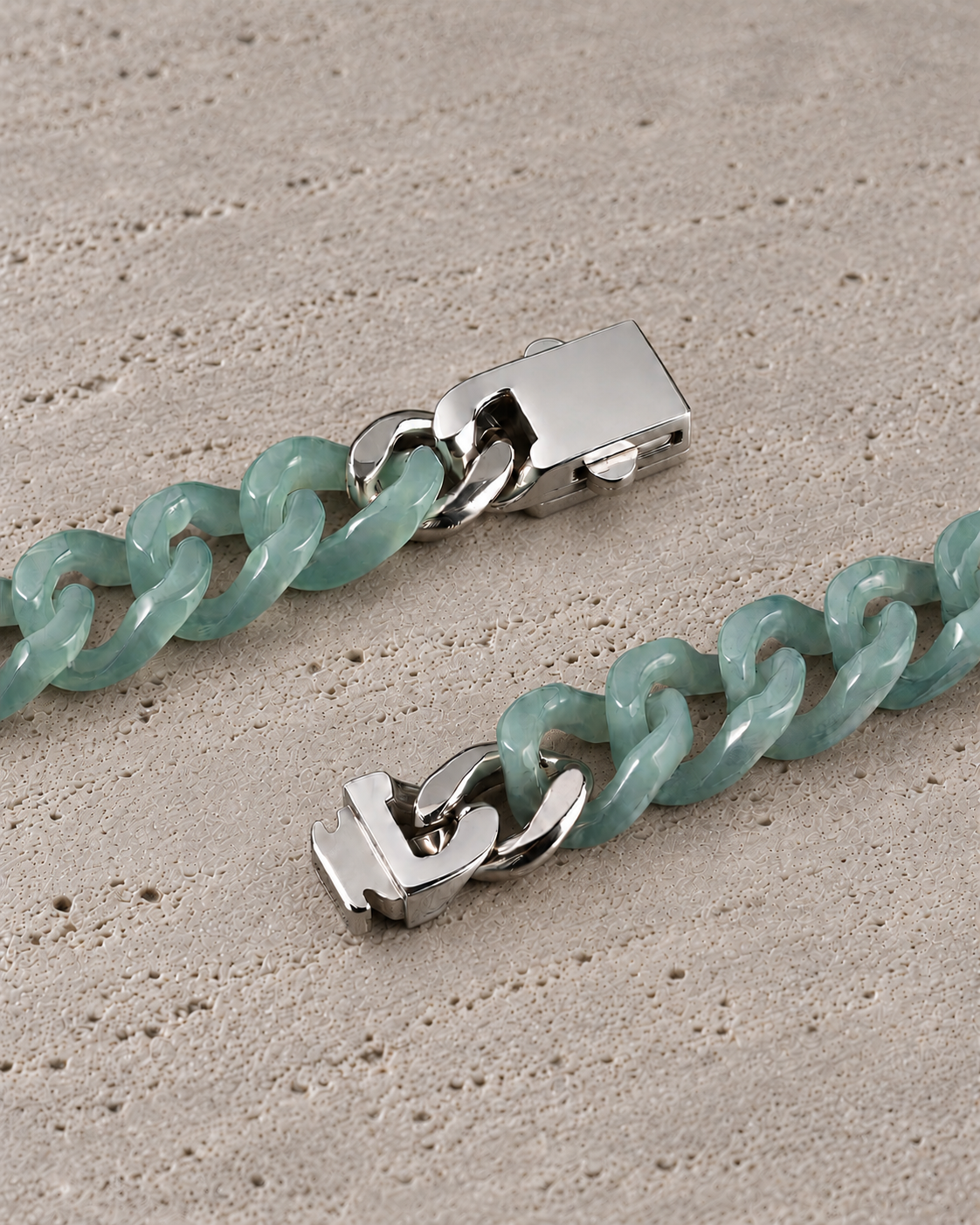 Single Piece Carved Cuban Chain Bracelet in Top Icy Green Jade, clasp close-up on matte grey stone.