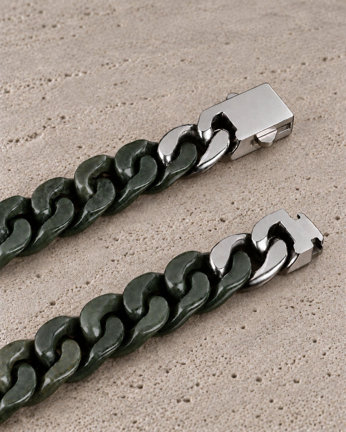 Classic Cuban Link Chain Bracelet in Dark Green Nephrite, clasp close-up on matte grey stone.