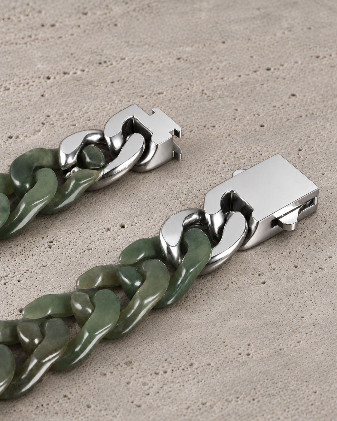 Classic Cuban Link Chain Bracelet in Light Green Nephrite, clasp close-up on matte grey stone.