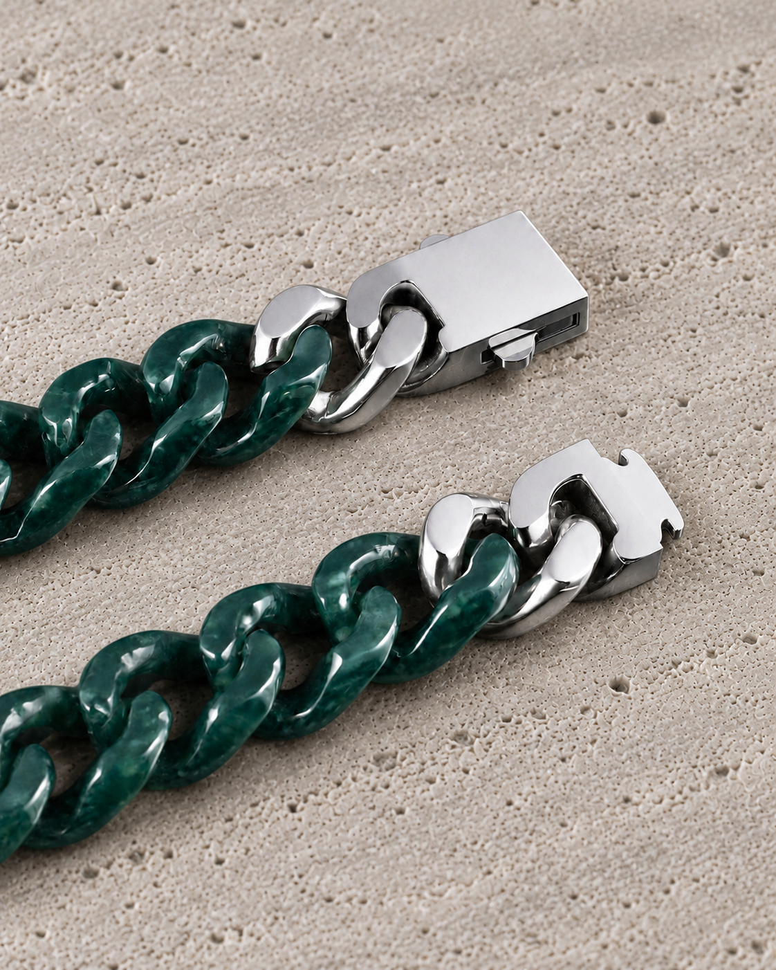 Single Piece Carved Cuban Chain Bracelet in Dark Green Jade, clasp close-up on matte grey stone.