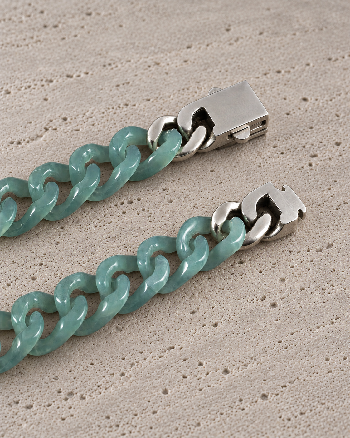 Single Piece Carved Cuban Chain Bracelet in Top Icy Green Jade, clasp close-up on matte grey stone.