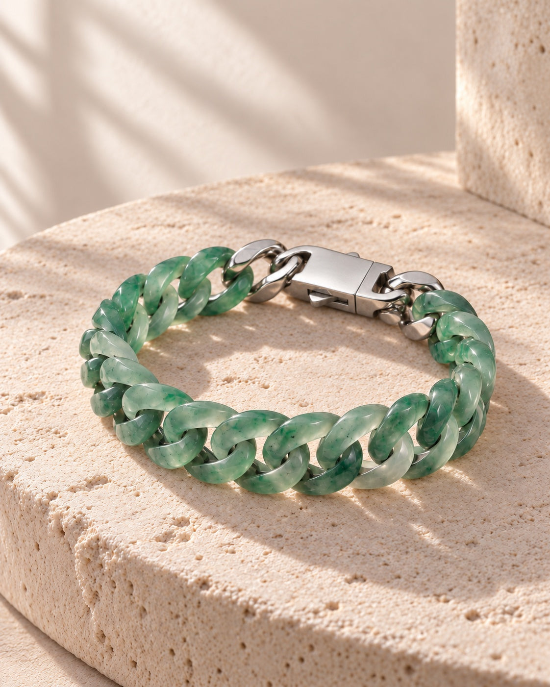 Classic Cuban Link Chain Bracelet In African Green Jade on white stone: Rounded travertine ledge