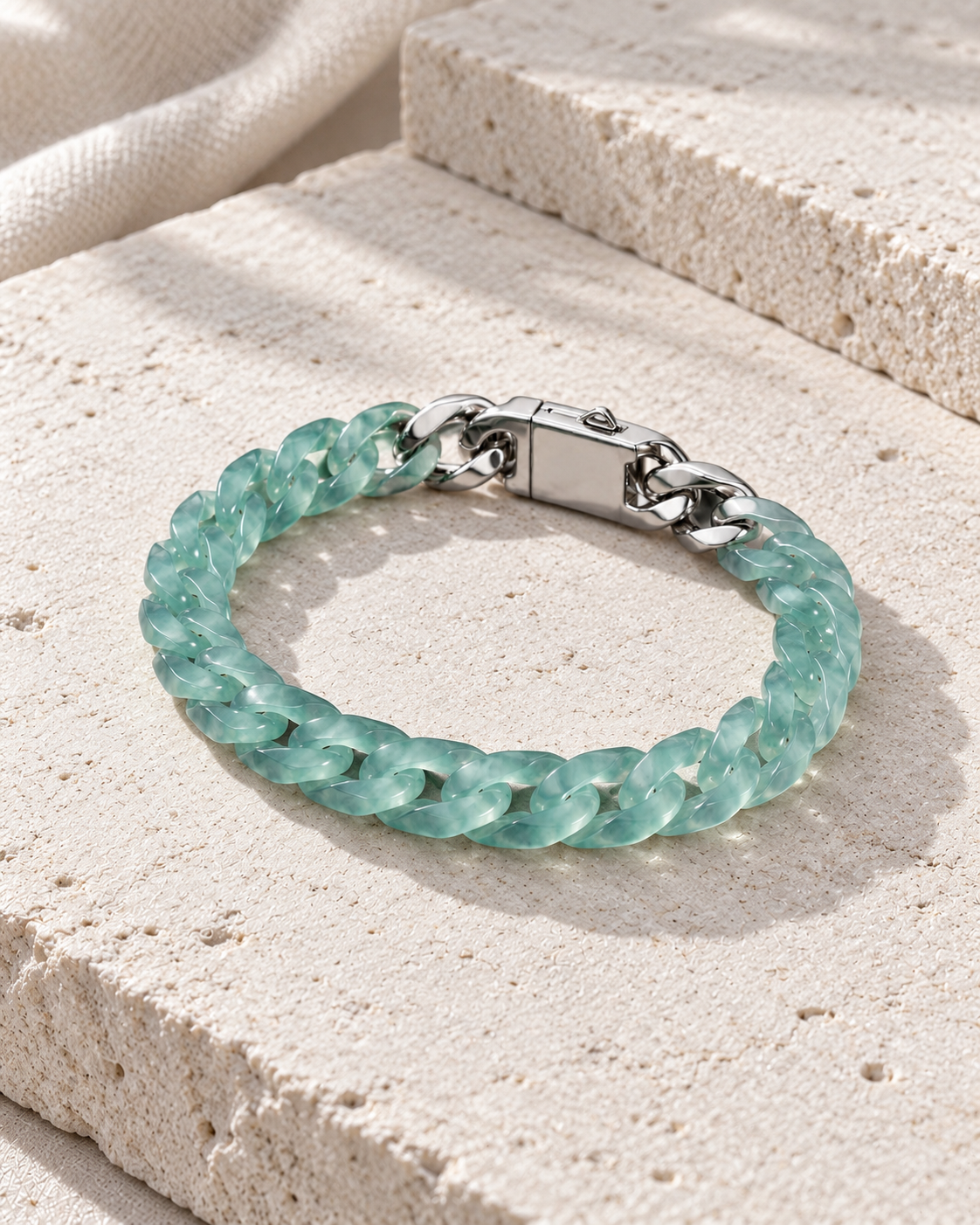Classic Cuban Link Chain Bracelet In Blue-Green Jadeite on flat pale stone