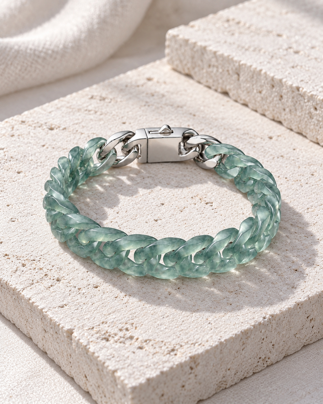 Classic Cuban Link Chain Bracelet In Top Icy Light Green Guatemalan Jade on flat pale stone