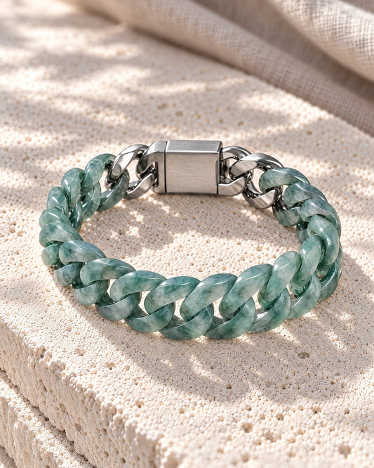 Classic Cuban Link Chain Bracelet In Blue-Green Jadeite on white stone, resting on its side