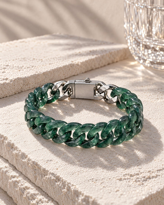 Classic Cuban Link Chain Bracelet In Jelly Green Mayan Jade resting on its side on pale stone in soft daylight