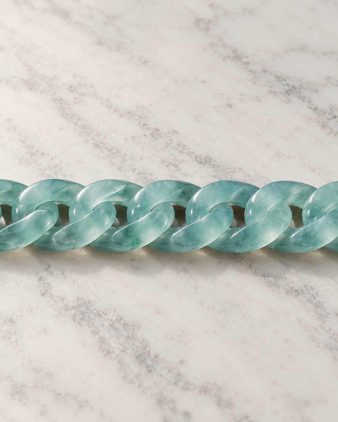 Classic Cuban Link Chain Bracelet In Blue-Green Jadeite on white stone: marble tabletop detail — 10 mm