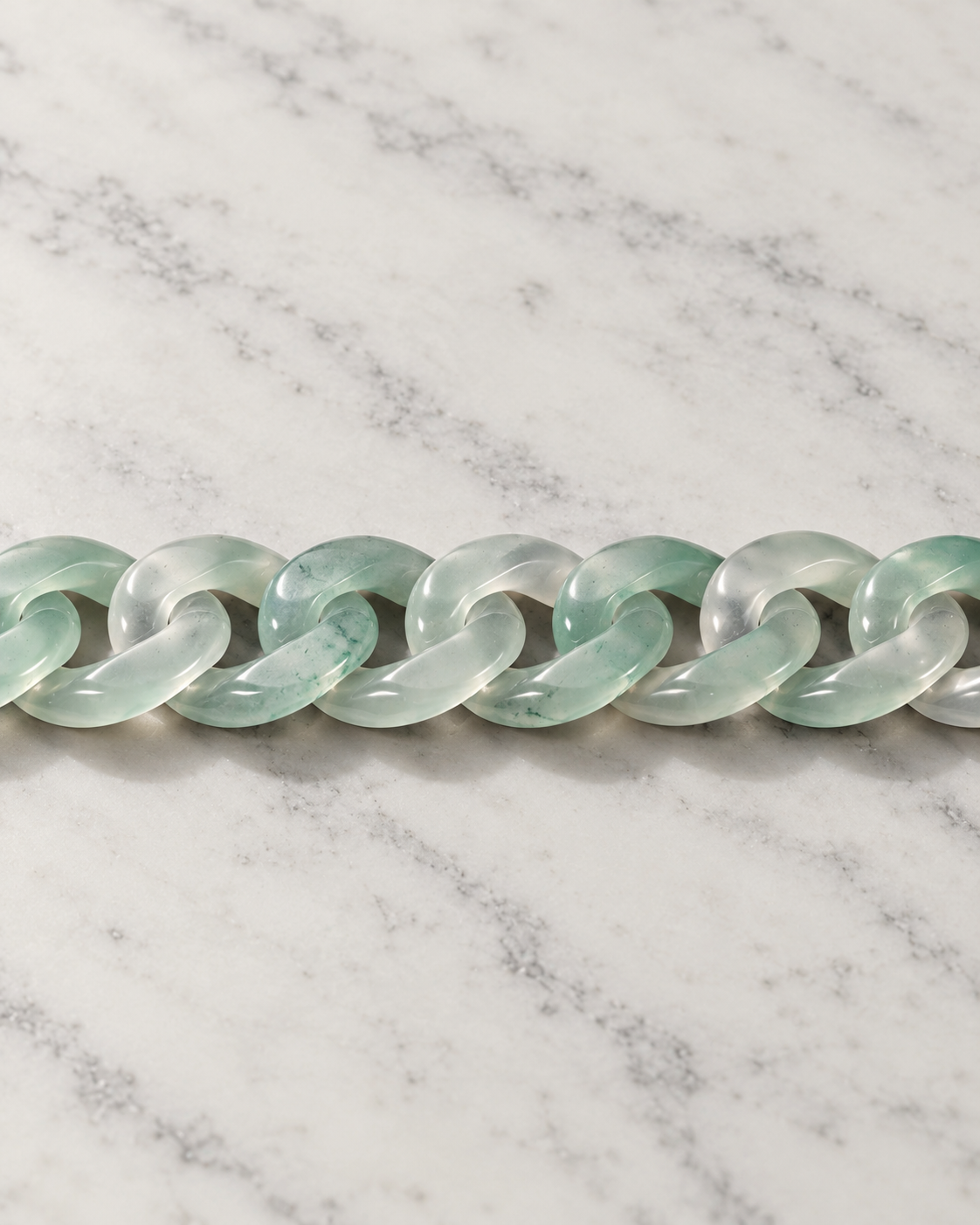 Classic Cuban Link Chain Bracelet In Light Green African Jade on white stone: marble tabletop detail