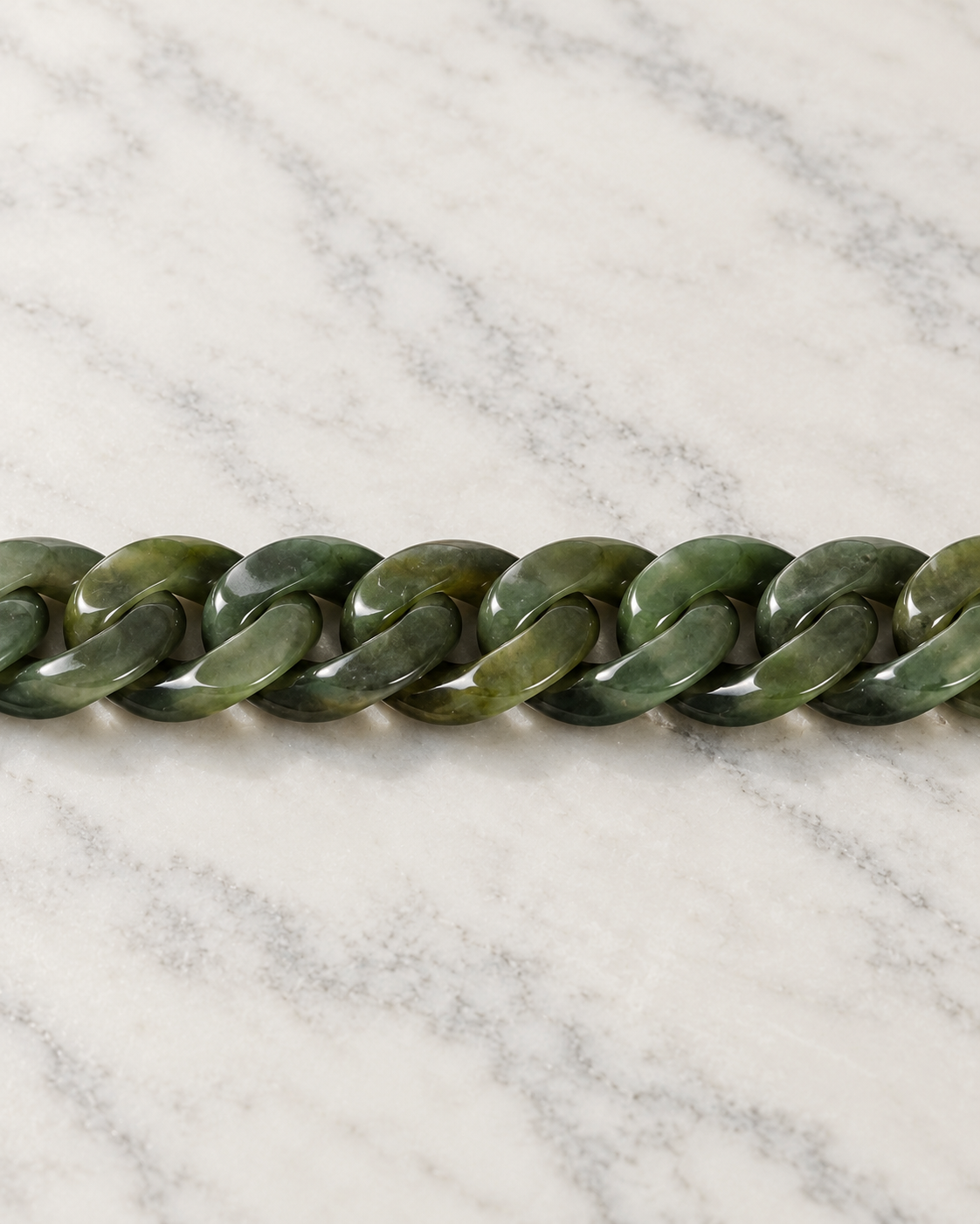 Classic Cuban Link Chain Bracelet In Light Green Nephrite on white stone: marble tabletop detail