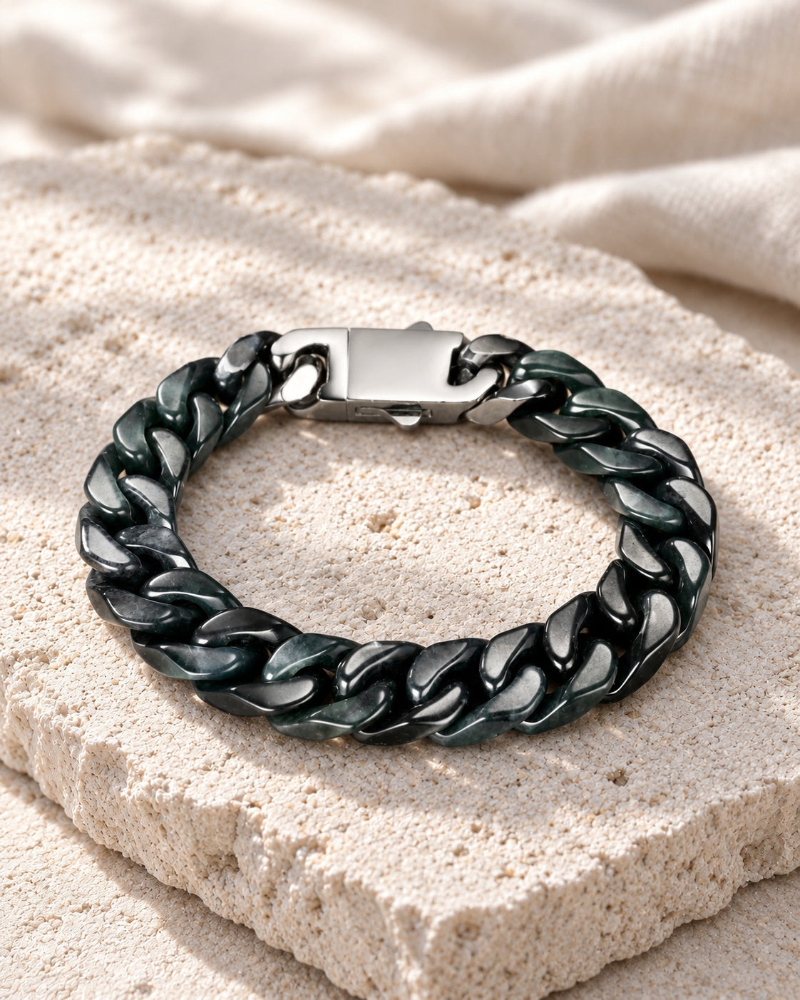 Classic Cuban Link Chain Bracelet In Black Jade on white stone: Angled limestone slab