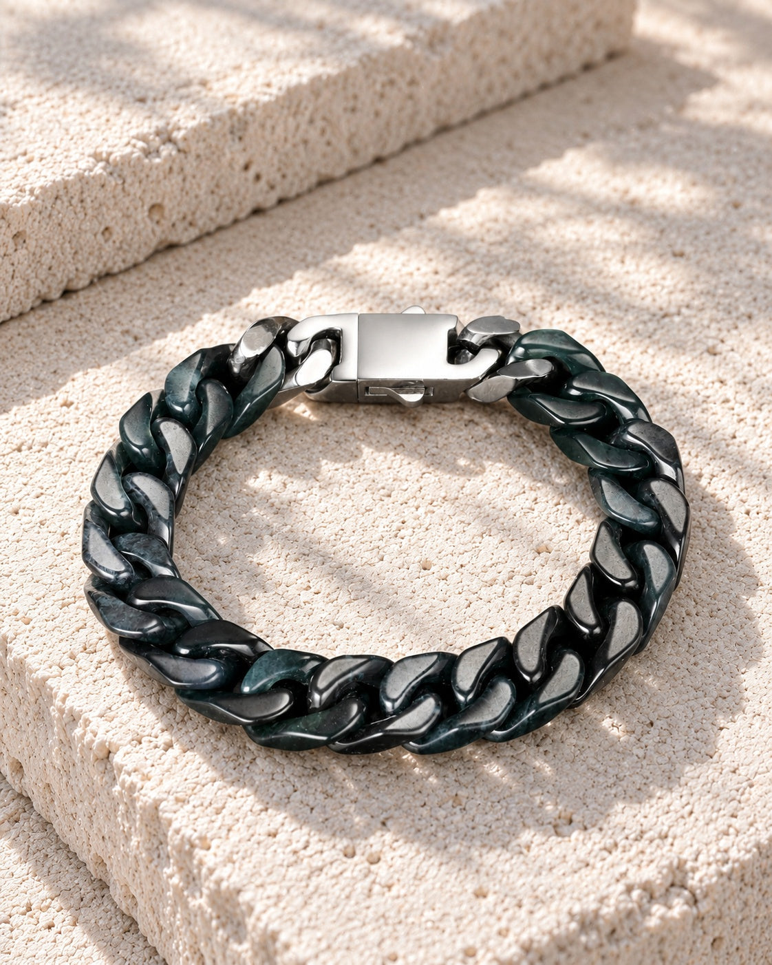 Classic Cuban Link Chain Bracelet In Black Jade on white stone: Offset white stone blocks