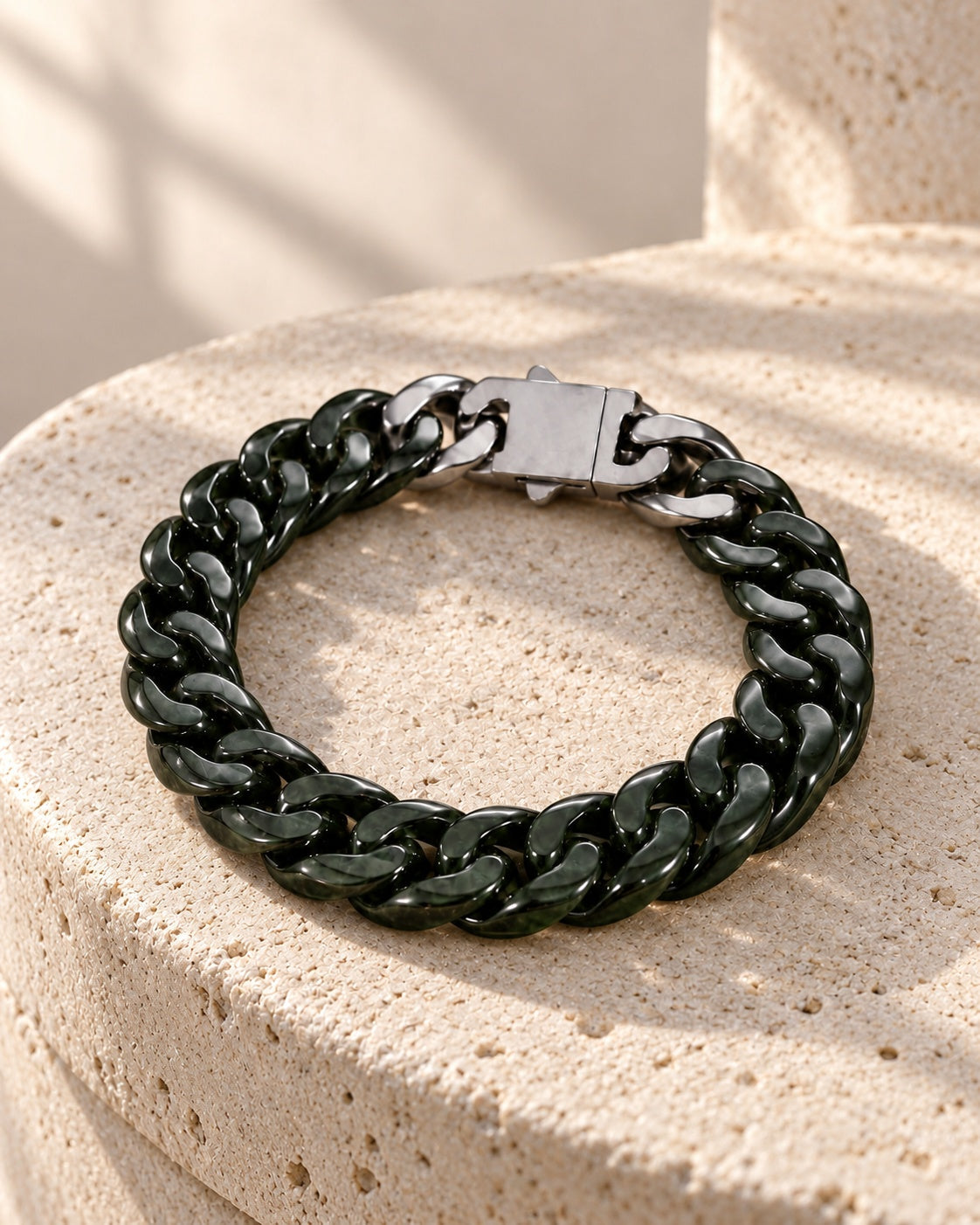 Classic Cuban Link Chain Bracelet In Dark Green Nephrite on white stone: Rounded travertine ledge