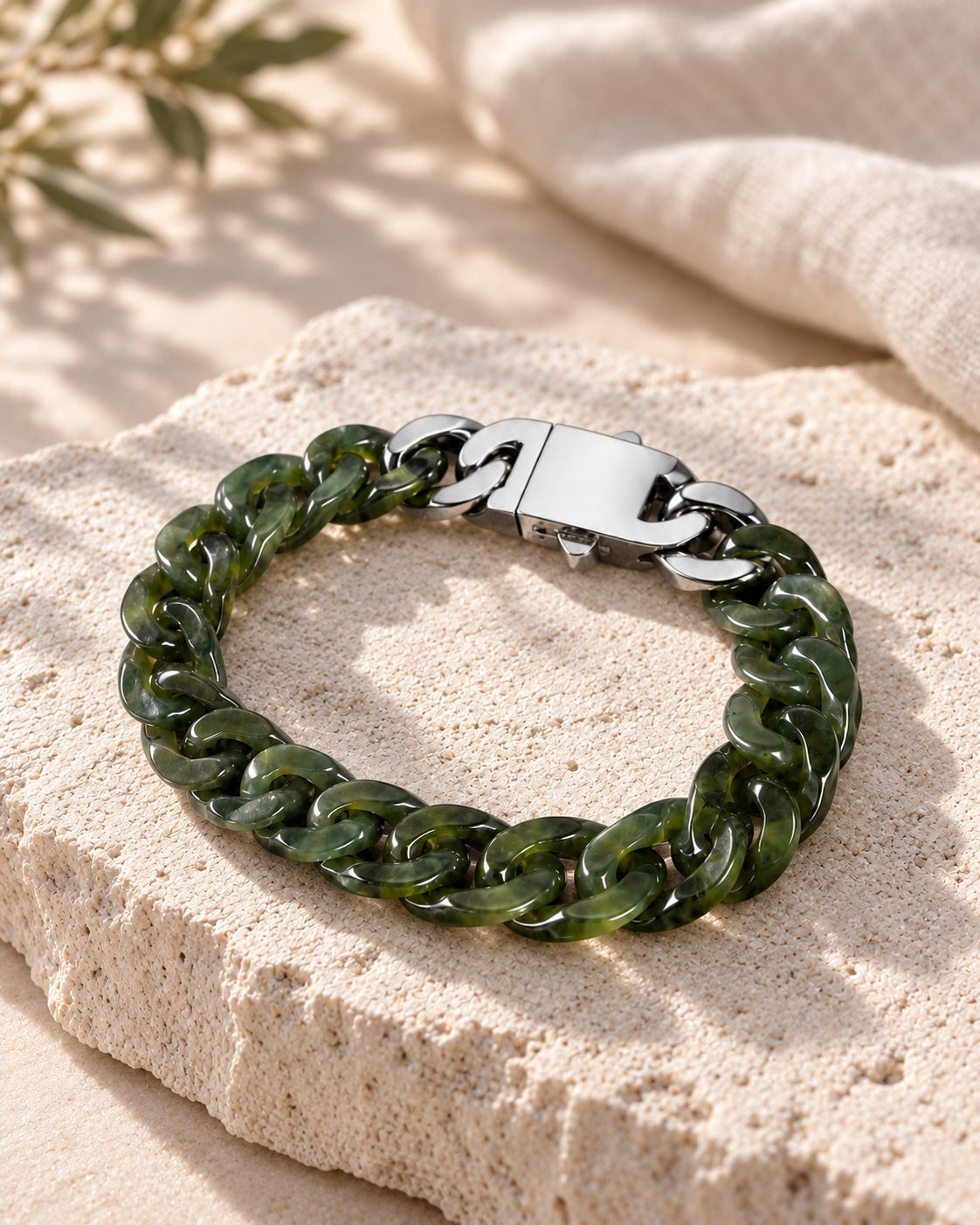 Classic Cuban Link Chain Bracelet In Light Green Nephrite on white stone: Angled limestone slab