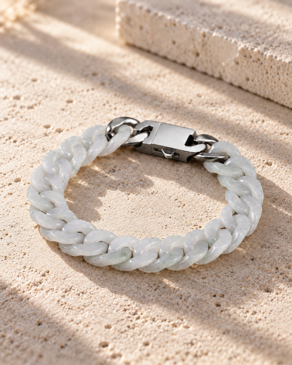 Classic Cuban Link Chain Bracelet In White Jade on white stone: Pale limestone tabletop