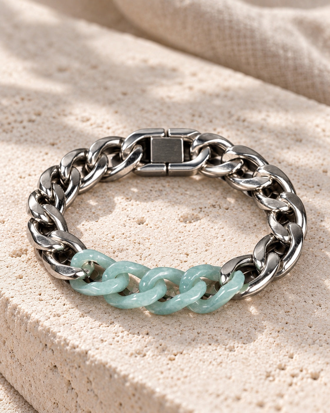 Classic Cuban Chain Bracelet In Green Jade With Stainless Steel on white stone: Soft curved stone surface