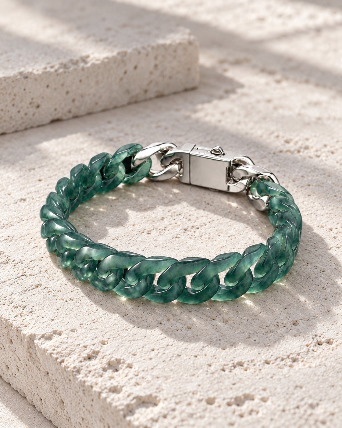 Classic Cuban Link Chain Bracelet In Top Icy Dark Green Guatemalan Jade on white stone: Pale limestone tabletop
