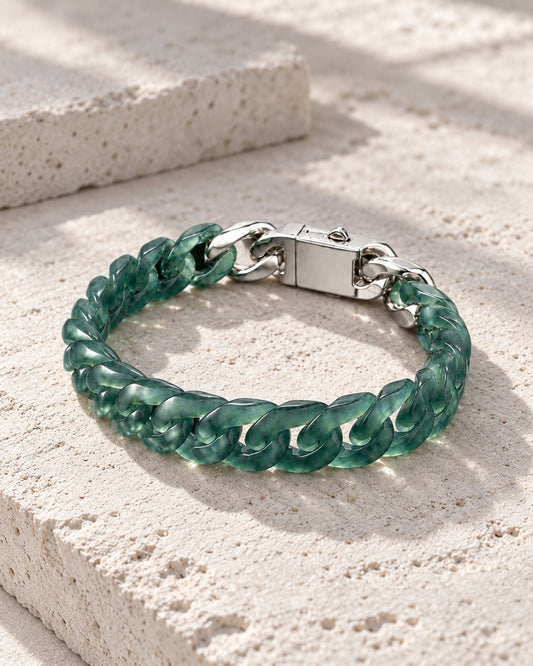 Classic Cuban Link Chain Bracelet In Top Icy Dark Green Guatemalan Jade on white stone: Pale limestone tabletop